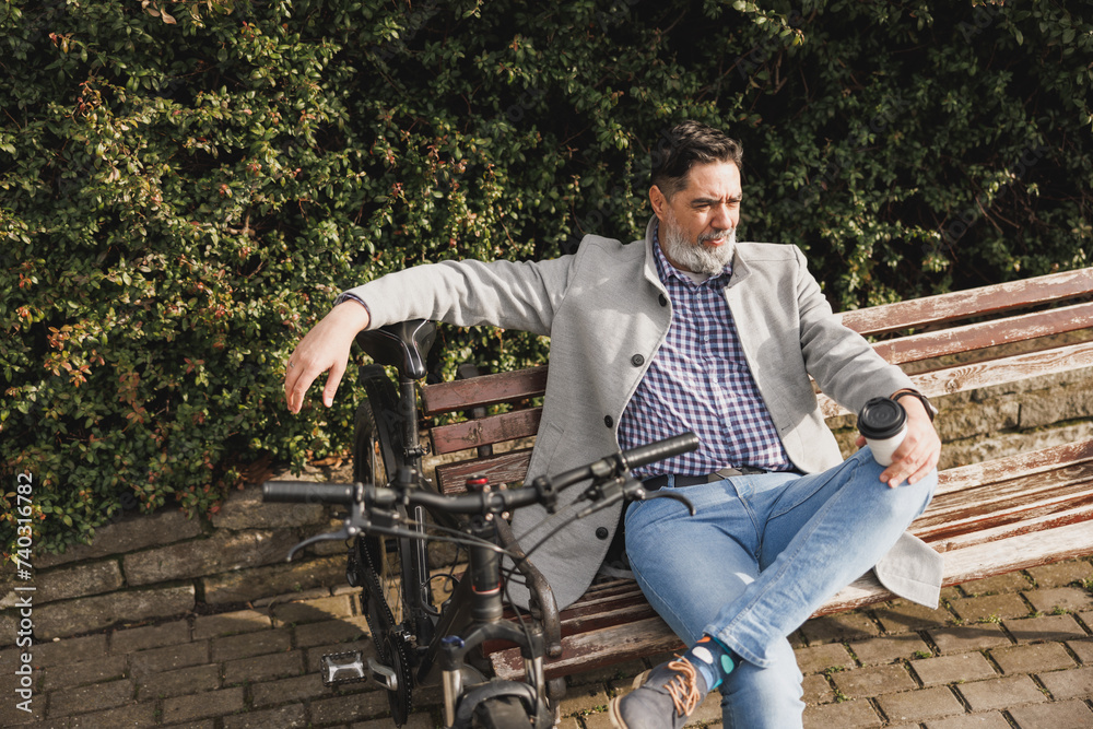 Man Sitting on Park Bench With Bike