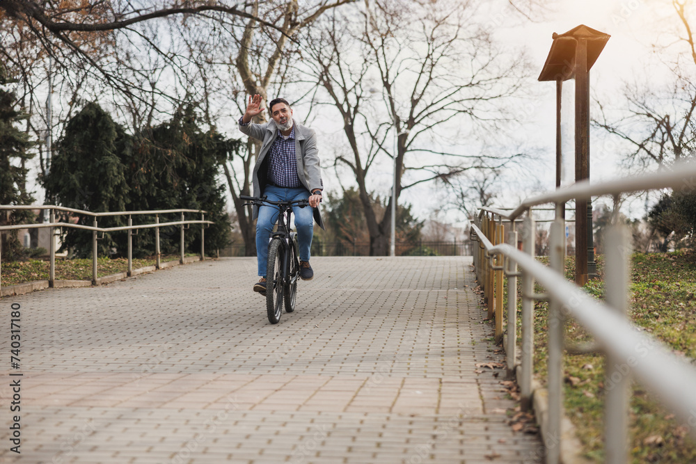 Man Riding Bike Down Sidewalk and Waving Man Riding Bike Down Sidewalk and Waving