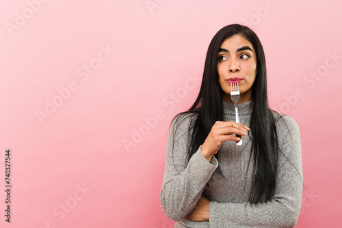 Konstfotografi Mexican hungry woman eating dinner with a fork