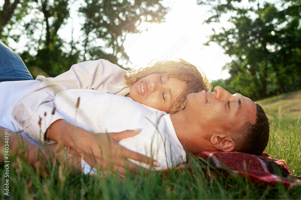 african american romantic young couple lies on the grass in the park and sleeps in nature, happy family rests african american romantic young couple lies on the grass in the park and sleeps in nature, happy family rests