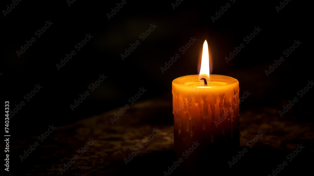 Close-up of a single unlit candle in a dark room.
