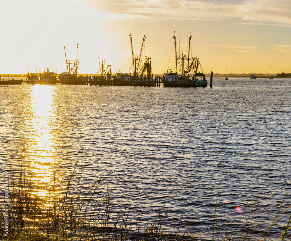 Fototapeta premium Shrimp Boats on The Amelia River at Sunset, Fernandina City, Amelia Island, Florida, USA
