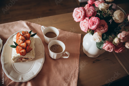 meringue cake combined with fresh strawberries on a background of a pink tablecloth