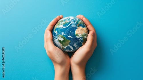Caring hands cradle earth on blue background, symbolizing responsibility, with text area