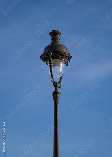 Parisian street lamp on blue sky background in Concorde Square 