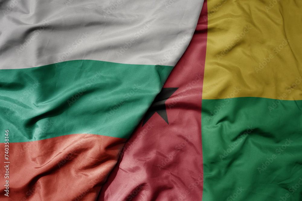 big waving national colorful flag of guinea bissau and national flag of bulgaria .