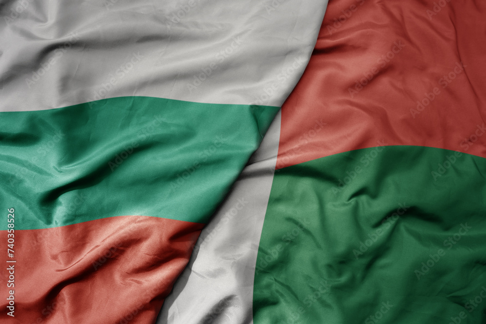 Obraz premium big waving national colorful flag of madagascar and national flag of bulgaria .