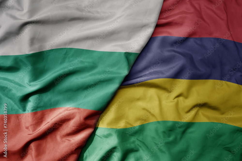 big waving national colorful flag of mauritius and national flag of bulgaria .