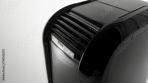 The sleek modern design of a portable air conditioner featuring a glossy black exterior and curved edges.