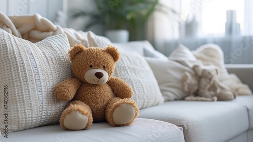 Charming teddy bear sitting on a cozy white sofa in a room with green plants