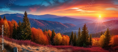 A stunning painting capturing the captivating autumn sunset over the majestic Beskidy Mountains. photo