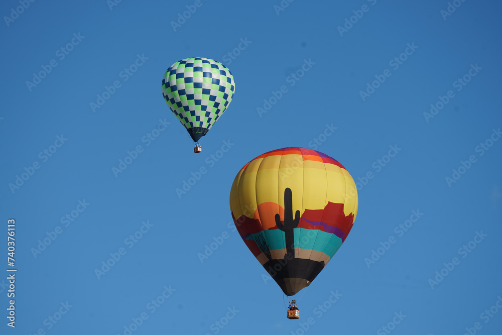 Obraz premium hot air balloons floating through blue skies