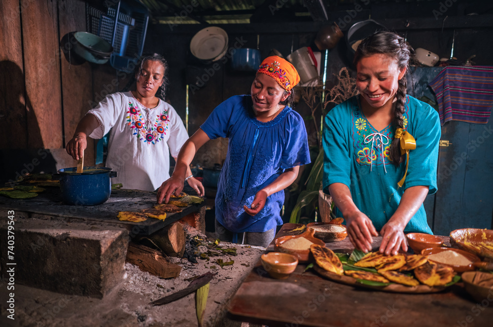 Latin women enjoy preparing sweet tamales and cooking them in a clay pan.