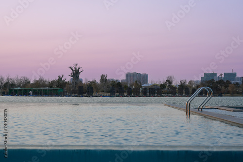 Infinity swimming pool in the resort at sunset