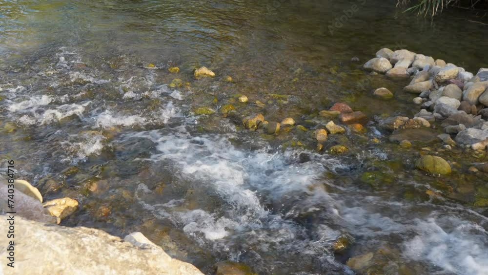 Shallow river stream with pebbles and rapids Shallow river stream with pebbles and rapids