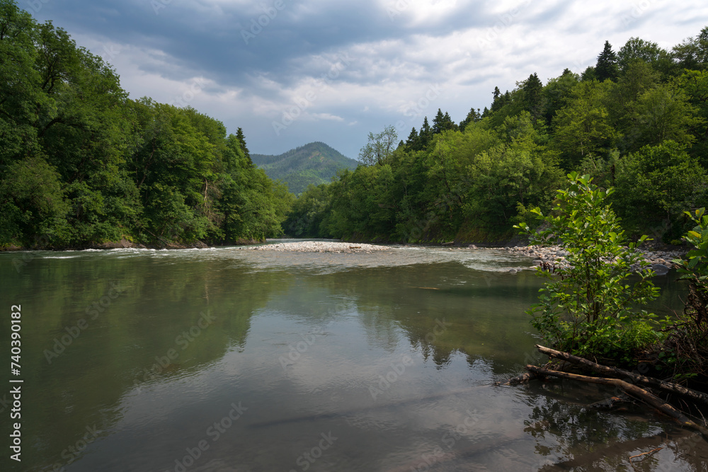 Belaya River canyon on the territory of the Caucasian Biosphere Reserve on the Guzeripl cordon on a sunny summer day with clouds, Guzeripl, Republic of Adygea, Russia Belaya River canyon on the territory of the Caucasian Biosphere Reserve on the Guzeripl cordon on a sunny summer day with clouds, Guzeripl, Republic of Adygea, Russia