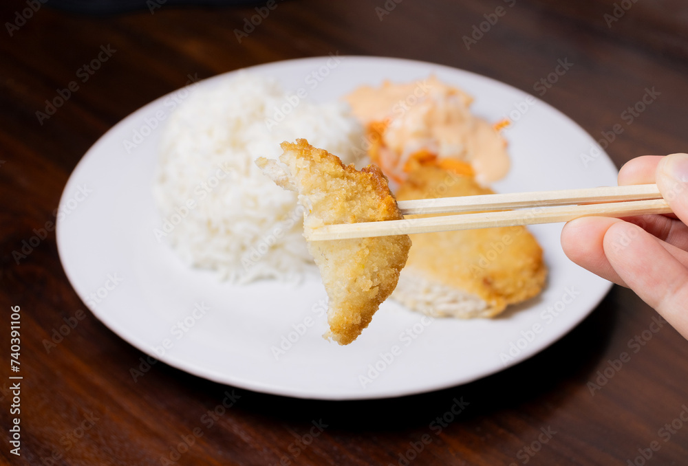 Rice with chicken katsu in white plate on wooden table. After some edits.
