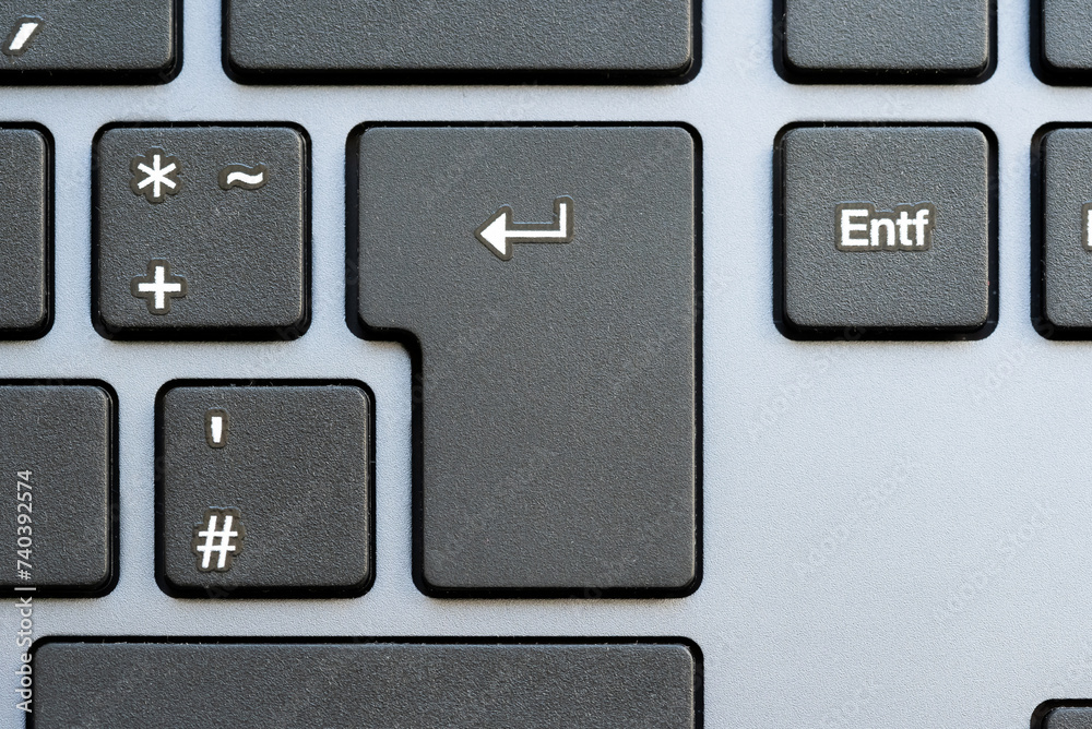 Close-up shot of an Enter key on a modern computer keyboard, completing an action, sending a chat message, applying for a job, confirmation, completion and accepting input simple abstract concept Close-up shot of an Enter key on a modern computer keyboard, completing an action, sending a chat message, applying for a job, confirmation, completion and accepting input simple abstract concept
