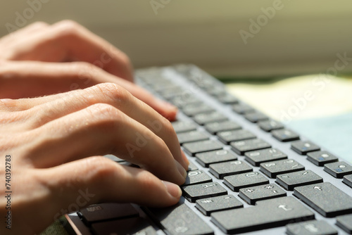 Close-up of a freelancers hands typing on a computer keyboard, productivity and digital online work modern office environment or home Blogging, writing, accounting desktop PC work job abstract concept