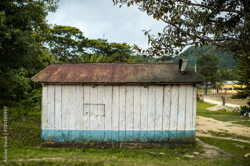 Rustic Wooden Shack with Corrugated Metal Roof, Rural Landscape in Guatemala Rustic Wooden Shack with Corrugated Metal Roof, Rural Landscape in Guatemala