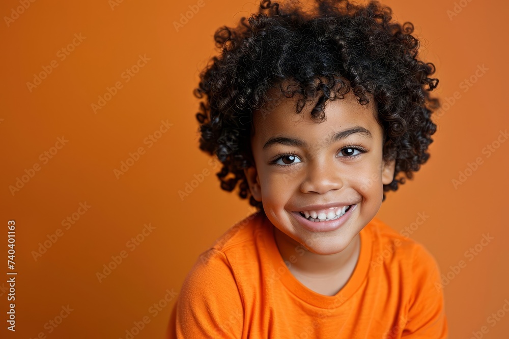 Portrait of a mixed race boy with a bright smile Showcasing joy and innocence in a studio setting Portrait of a mixed race boy with a bright smile Showcasing joy and innocence in a studio setting
