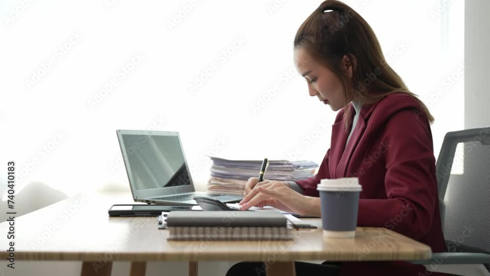 Asian business woman working at office with documents on table Planning to analyze financial reports business plan investment Young Asian woman accounting for sales invoices Asian business woman working at office with documents on table Planning to analyze financial reports business plan investment Young Asian woman accounting for sales invoices
