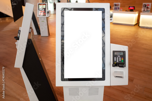 Blank white mockup background texture template of a kiosk machine with a touch screen and an attached POS machine. Copy space on a smart interactive machine service device for customer self-checkout. photo