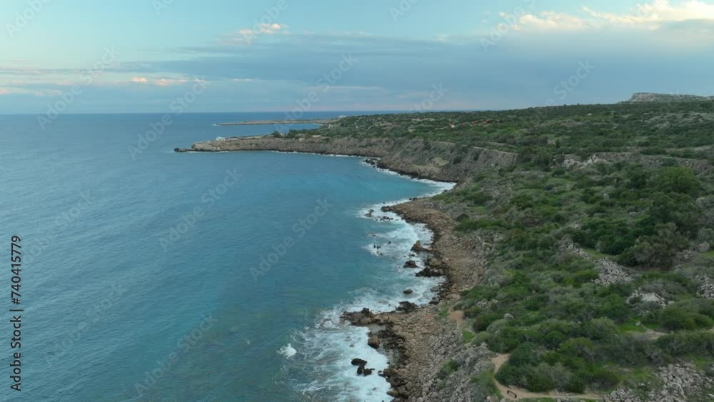 Rocky Konnos Beach with waves of Mediterranean Sea in Cyprus. Cloudy day in the evening. Aerial birds eye shot.
Rocky Konnos Beach with waves of Mediterranean Sea in Cyprus. Cloudy day in the evening. Aerial birds eye shot.