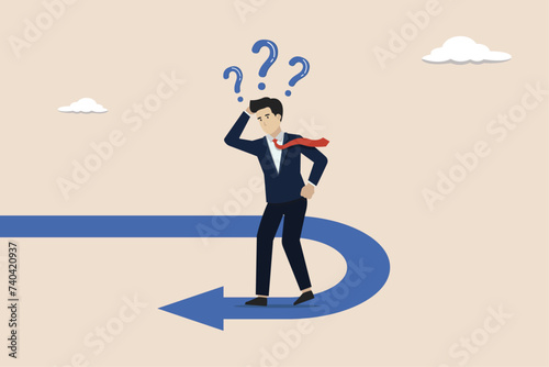 Business turning point, change direction,interest rate or financial trend change concept, businessman investor confused looking at reverse direction path.