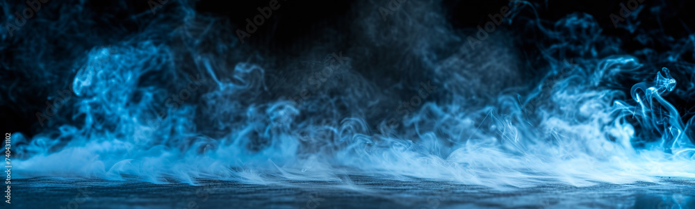 Obraz premium Ground blue smoke on black background. Dark smoke banner