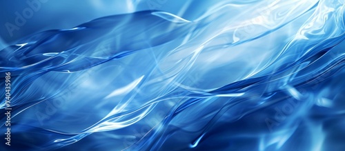 A close up of an electric blue background with a swirling pattern resembling water, liquid, sky, clouds, and wind, creating an artistic paintinglike effect photo