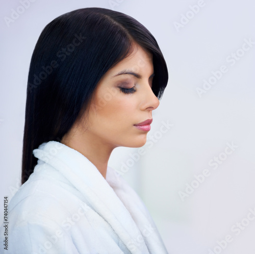 Woman, profile and skincare or makeup in studio, cosmetics and bathrobe for pamper aesthetic. Female person, white background and facial treatment for beauty, dermatology and glowing in daily routine