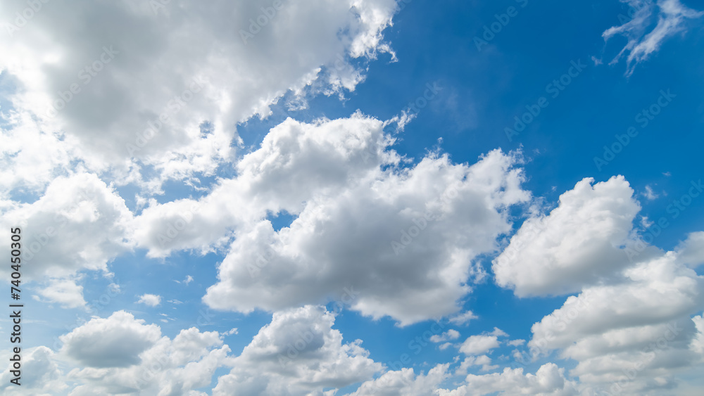 Fototapeta premium Panoramic view of clear blue sky and clouds, Blue sky background with tiny clouds. White fluffy clouds in the blue sky. Captivating stock photo featuring the mesmerizing beauty of the sky and clouds.