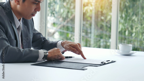 Businessman hands note meeting document in conference room. man Hands writing planning notebook. Close up male hand holding pencil write on diary sketchbook at office desk. Business Planning Concept photo