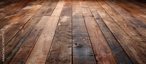 The image features a wooden floor with a prominent brown stain. The distressed wood adds character, while the rich color of the stain creates a warm and inviting ambiance.
