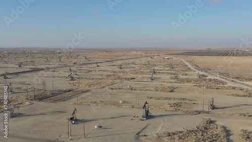 Drone flight forward over oil pumps in Central California, USA.