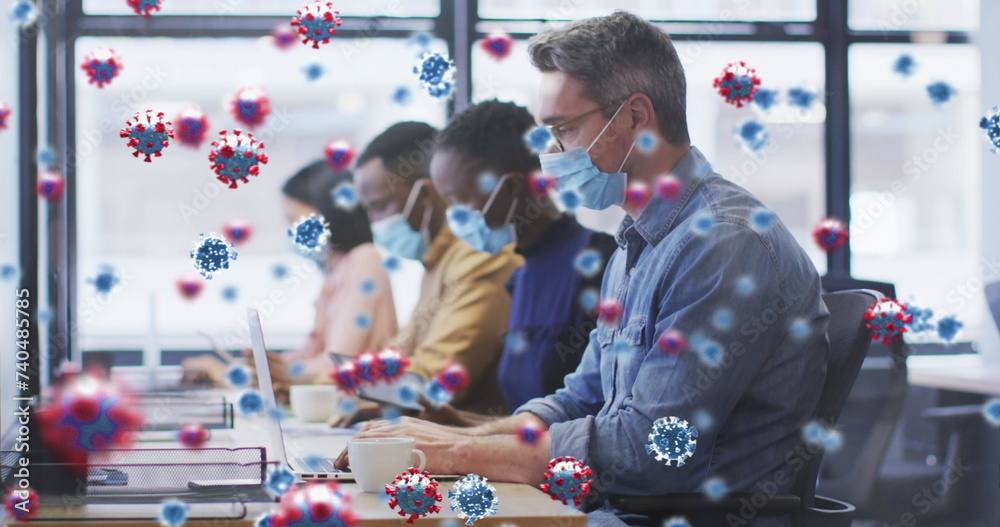 Obraz premium Image of virus cells floating over diverse business people with face masks in office