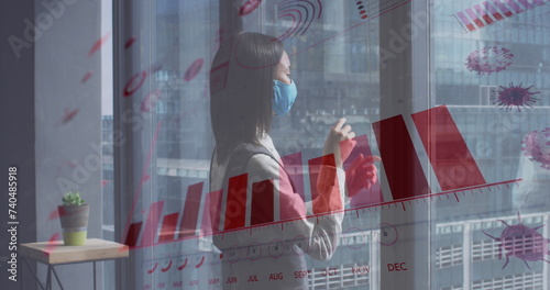 Image of financial data processing over asian businesswoman with face mask thinking in office