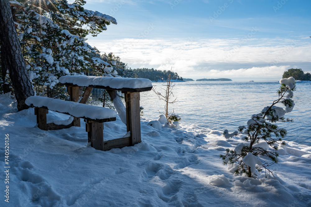 Bench and small table overlooking lake Vattern Motala Sweden