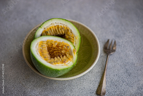 Plate with halves of passion fruit photo