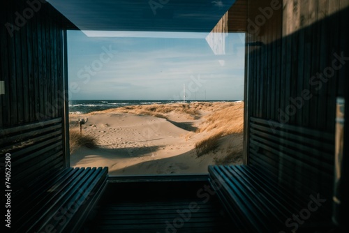 A large window, and behind it the dunes, the sun and the Baltic Sea