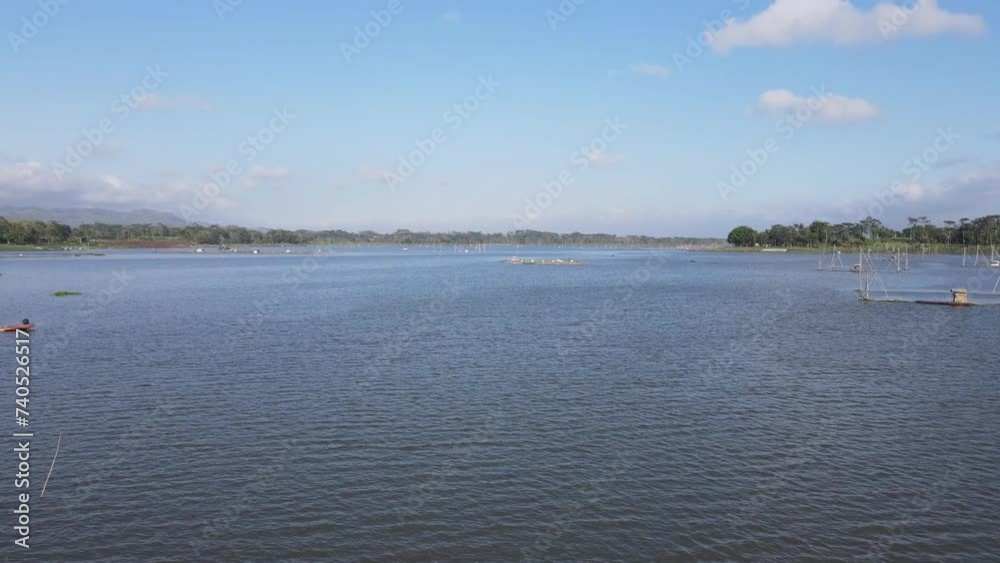 Aerial drone view of lake waves. Sun reflection on the water surface. Panoramic view of shrimp pond in the lake