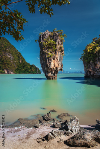 Majestic James Bond Island in Thailand's Phang Nga Bay: Iconic limestone stack surrounded by azure waters and lush greenery