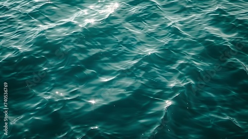 Blue green surface of the ocean in Catalina Island California with gentle ripples on the surface and light refracting
