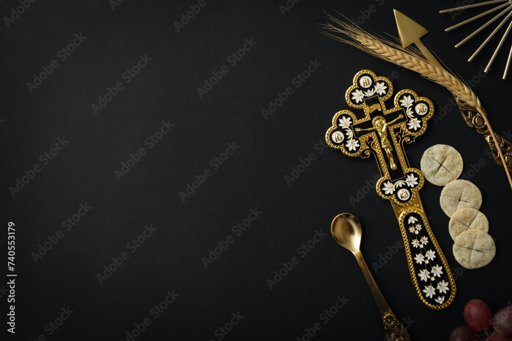 Naklejka premium Bread, cross, spikelets and cutleries on black background, space for text