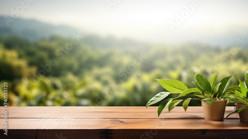 Wooden table top with blurry tea plantation landscape against blue sky and blurred green leave frame Product Display stand natural background concept