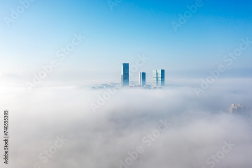 Aerial view of the city in the fog. Skyscrapers above the fog