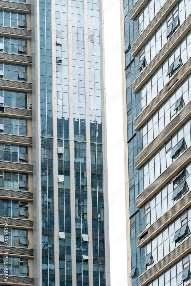 A beautiful background of an glass office building, reflecting clouds in the opened windows A beautiful background of an glass office building, reflecting clouds in the opened windows