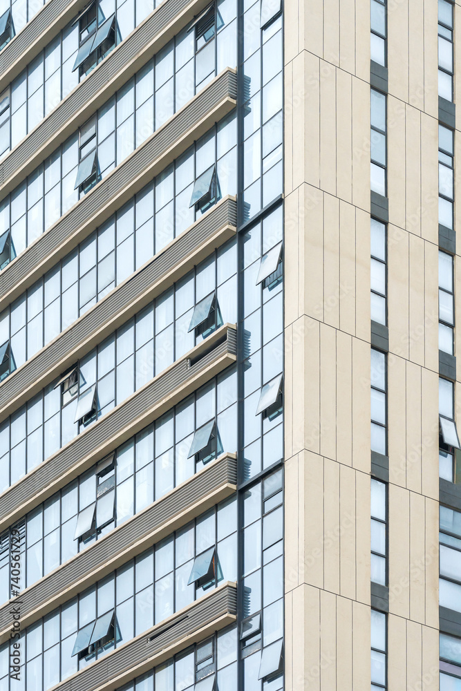 A beautiful background of an glass office building, reflecting clouds in the opened windows A beautiful background of an glass office building, reflecting clouds in the opened windows