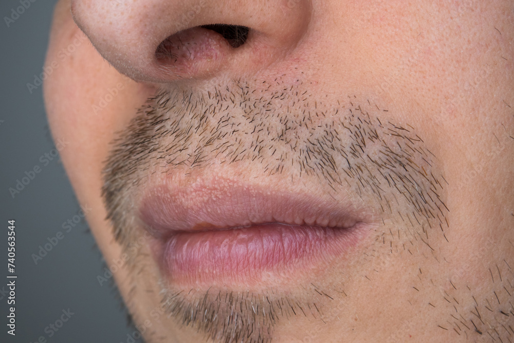 Fototapeta premium Caucasian male with uneven stubble, unshaven, close up shot, unrecognizable, no eyes